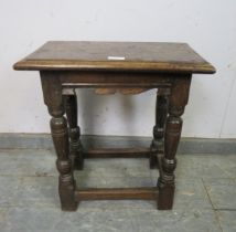 An antique oak joint stool in the 17th century taste with shaped frieze, on turned supports with