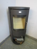 A contemporary cast-iron multifuel stove by Morso (model 7443) having a curved glass door with