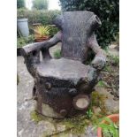 A large 19th century naturalistic stoneware garden seat, modelled as a tree stump with backrest in