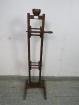 A 19th century oak floor-standing wool winder, surmounted by a mahogany cup, above a height