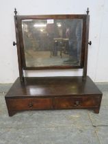 A Regency Period mahogany swing vanity mirror, retaining the original nicely silvered bevelled