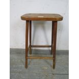 A vintage stained pine artist’s stool, on canted supports with stretchers. H60cm W33cm D20cm (