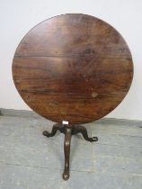 A George III Cuban mahogany tilt-top ‘birdcage’ table, on a turned and spiral carved column with