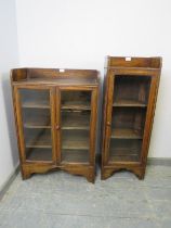 Two vintage oak glazed bookcases, with ¾ galleries, housing two and three shelves respectively, on