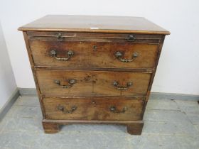 An 18th century mahogany chest, having a pull-out brushing slide above three graduated cock-beaded