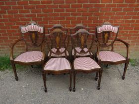 A set of six (4+2) Edwardian mahogany marquetry inlaid dining chairs, reupholstered in a Regency