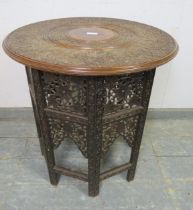 An early 20th century Angle Indian hardwood occasional table, the circular top with relief carving