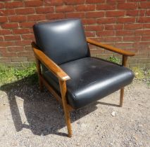 A mid-century style elm lounge chair by West Elm, upholstered in supple black leather