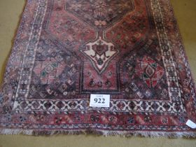 A 20th Century Qashqai rug. Central pointed medallion on a red/pink ground bordered in cream. 158