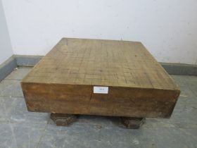 An antique Japanese Go board, on carved octagonal bun feet. H22cm W43cm D43cm (approx). Condition