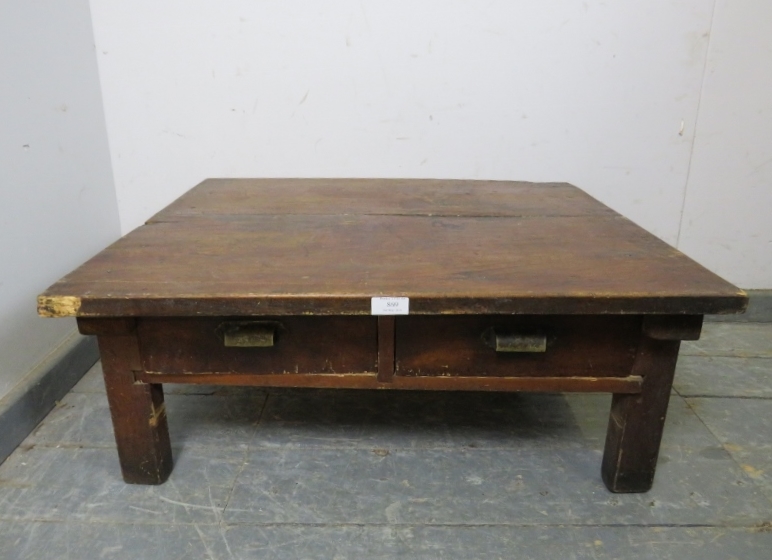A vintage Japanese fruitwood low coffee table, housing two short drawers with brass scalloped