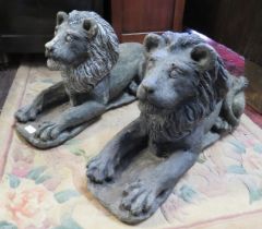 A pair of well rendered reconstituted stone lions passant, on plinth bases. H37cm W26cm D64cm (