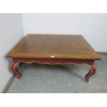 A reproduction oak rectangular coffee table, the burgundy painted base with shaped frieze above ogee