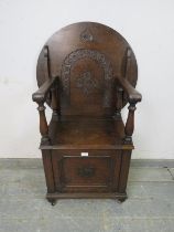 An antique oak metamorphic monk’s chair/occasional table in the 17th century taste, the circular