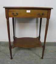 An Edwardian mahogany two-tier worktable, having one long frieze drawer with reeded brass handles