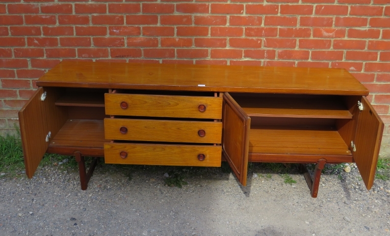 A mid-century teak sideboard, having three short drawers with turned wooden handles, flanked by - Bild 3 aus 3