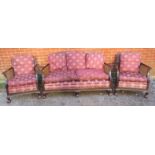 An antique mahogany bergère three-piece suite, comprising a two-seater sofa and two armchairs,