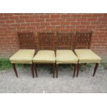 A set of four antique mahogany Regency Revival dining chairs, having gilt brass mounts,