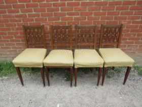 A set of four antique mahogany Regency Revival dining chairs, having gilt brass mounts,