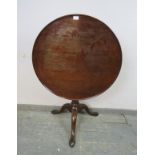 A George III mahogany ‘birdcage’ tilt-top table, the dished top above a plain tapering column with