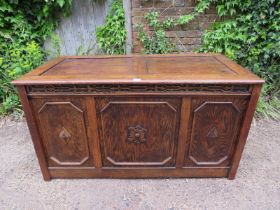 A large antique oak and pitch pine panelled coffer in the 17th century taste, the front with blind