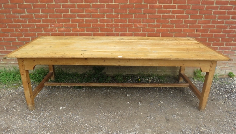 An antique pine refectory style farmhouse table, the planked top on square supports united by an ‘H’