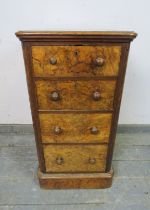 A Victorian figured walnut pedestal cabinet housing four graduated drawers with turned wooden