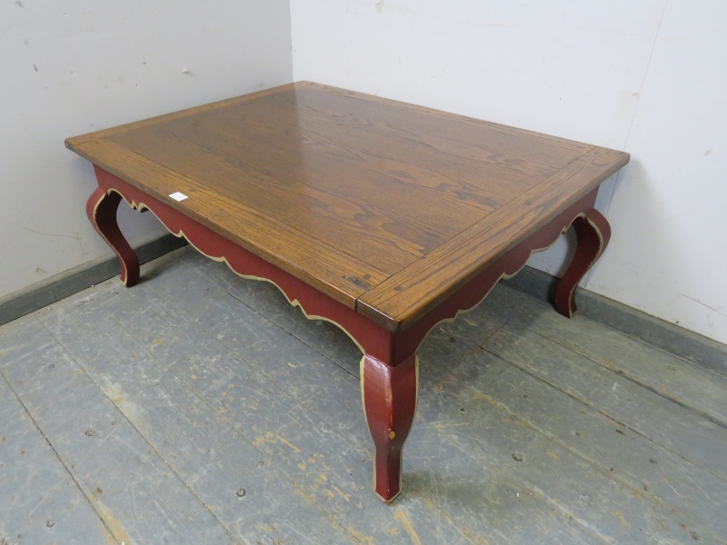 A reproduction oak rectangular coffee table, the burgundy painted base with shaped frieze above ogee - Image 2 of 3