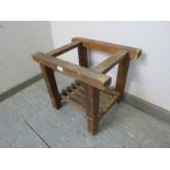 A vintage pine freestanding luggage rack, with slatted shelf below, on square supports. H43cm