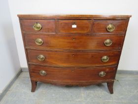 A George III mahogany bow-fronted chest strung with boxwood, housing three short above three long