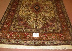 North West Persian Tabriz rug, central motif surrounded by foliage on cream/brown field. 182cm x