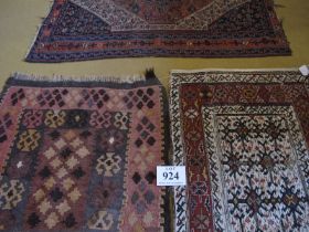 Three early mid 20th Century Kilim rugs, one pink and brown 94 x 82cms, one cream and red 102 x