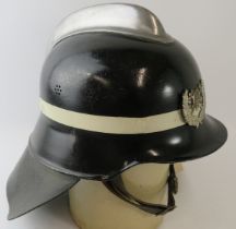 An unusual 1970s German pattern Spanish Fire Service black fire helmet with polished metal comb