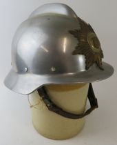 A 1970s Danish Fire Service steel fire helmet with brass badge