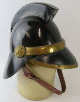 A 1920s British leather and brass fire helmet with square comb