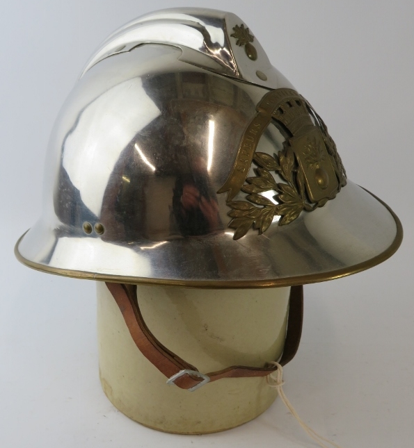 A 1970s French Sapeurs Pompiers Fire Service polished chrome fire helmet with brass mounts.