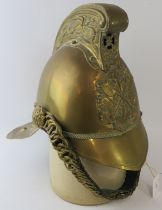 An early 20th century British brass Merryweather fire helmet with chin strap