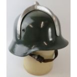 A 1950s German style Hungarian Fire Service steel fire helmet with polished metal mount