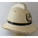 A 1960s British Army Fire Service white cork fire helmet