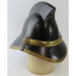 A 1950s British Hendry brass mounted fire helmet with pointed comb.