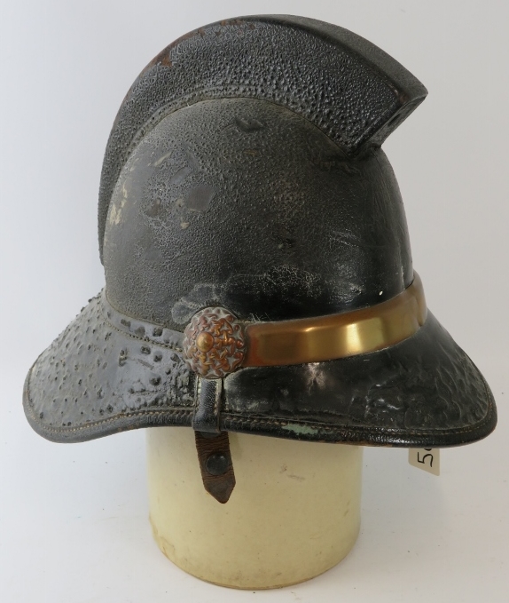 A British 1950s Hendry brass mounted fire helmet with square comb.