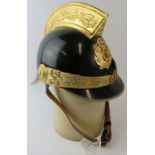 A Greek Athens Fire Brigade black steel fire helmet with brass mounts and badge