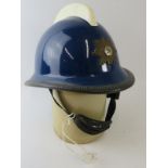 A 1970s Norwegian Fire Service blue fibreglass fire helmet with white comb and mounted badge