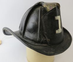 A 1950s US Fire Department (No 1) leather beaver tail helmet with Cairns & Brother label