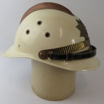 A 1970s Brazilian Fire Service white fire helmet with brass mounts.