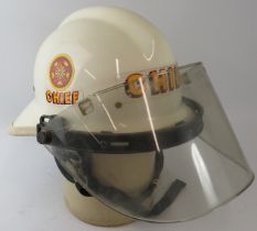 A 1970s American US Fire Department white Fire Chief's helmet with visor