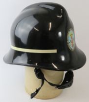 A 1970s Spanish Seville Fire Service ABS black fire helmet.