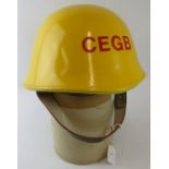 A British CEGB power station fire service yellow leather covered fire helmet