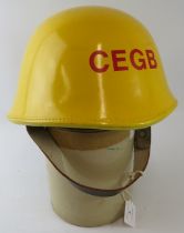 A British CEGB power station fire service yellow leather covered fire helmet