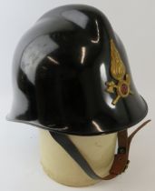 A 1980s Italian Fire Service black carbonfibre fire helmet with brass badge